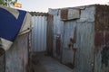 Closeup of old abandoned garages under the sunlight with the flag of Spain on the background