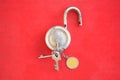 Closeup the old brass metal door lock with key and key ring over out of focus red background Royalty Free Stock Photo