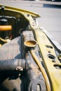 Closeup old car radiator with open cap filling water