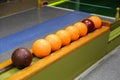 Closeup of old colorful bowling balls on a row under the lights