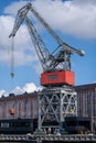 Closeup of an old decomissioned harbor crane against vivid sky Royalty Free Stock Photo