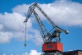 Closeup of an old decomissioned harbor crane against vivid sky Royalty Free Stock Photo