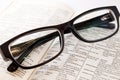 Closeup of old dictionary and glasses