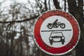 Closeup of an old dirty road sign surrounded by trees with a blurry background Royalty Free Stock Photo