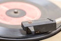 Closeup of old and dusty vinyl record player with arm and needle in focus Royalty Free Stock Photo