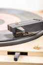 Closeup of old and dusty vinyl record player with arm and needle in focus Royalty Free Stock Photo