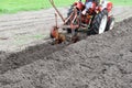 Ploughing with old-time plough with two plow blades