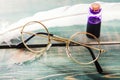 Closeup of old glasses near quill and inkstand on green wooden table