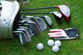 Closeup old golf bags on green. Set of golf clubs over green field background Royalty Free Stock Photo