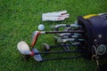 Closeup old golf bags on green. Set of golf clubs over green field background Royalty Free Stock Photo