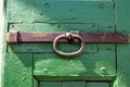 Green wooden door with iron rusty latch Royalty Free Stock Photo