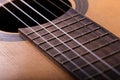 Closeup of old guitar body with sound hole and strings Royalty Free Stock Photo
