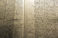 Closeup of an old handwritten Italian religious text under the lights