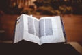 Closeup of an old Hebrew Bible under the lights with a blurry background