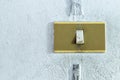 A closeup in a old light switch on the old white wall. Royalty Free Stock Photo