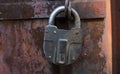 Closeup of old lock on red metal door. Old iron lock on the door. Royalty Free Stock Photo