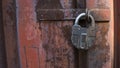Closeup of old lock on red metal door. Old iron lock on the door. Royalty Free Stock Photo