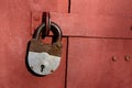 Closeup of old lock on red metal garage door Royalty Free Stock Photo