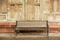 Closeup old long bench on wooden wall of house background Royalty Free Stock Photo