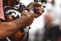 Closeup of an old man hands playing mandolin