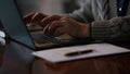 Closeup old man hands typing on computer at home. Male arms using laptop indoors Royalty Free Stock Photo