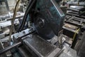 Closeup of an old metal cutting machine in a factory under the lights with a blurry background Royalty Free Stock Photo