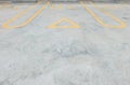 Closeup surface old and pale yellow painted sign for parking slot line on cement street floor in the car park with DC word sign te Royalty Free Stock Photo