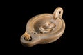 An old roman oil lamp, black background