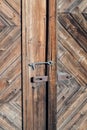 Closeup of an old rusted lock on a rustic rural door with decorative natural weathered wood planks with antique varnish Royalty Free Stock Photo