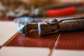 Closeup of an old, rusty, plumbing wrench. Focus on connecting sc