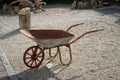 Closeup of an old rusty and weathered metallic wheelbarrow in the garden Royalty Free Stock Photo