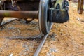 Closeup of an old steam locomotive steel wheel on a track including the rusted axle. Royalty Free Stock Photo