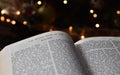 Closeup of the Book of Kings in the Bible with soft lights in a dark background