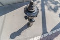 closeup of old weathered fire hydrant on street. black fire hydrant with shadow. Top view. help for fire brigade Royalty Free Stock Photo