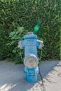 closeup of old weathered fire hydrant on street. Blue fire hydrant on the pavement. Front view. help for fire brigade