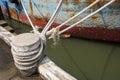 Old weathered rope white with a knot securing a fishing boat Royalty Free Stock Photo