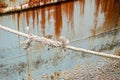 Old weathered rope white with a knot securing a fishing boat