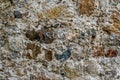 Closeup of weathered old stone wall structure with mortar Royalty Free Stock Photo