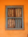 old window with terra-cotta tiled roof. An architectural details from Goa, India. Royalty Free Stock Photo