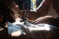 Closeup of an old woman hands using a sewing machine Royalty Free Stock Photo