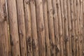 closeup old wooden fence of logs in form of palisade Royalty Free Stock Photo