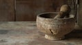 A closeup of an old wooden mortar and pestle worn smooth from years of grinding various plants and herbs for medicinal