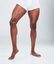 Closeup of one African American fitness model posing in a underwear and looking muscular. Confident black male athlete Royalty Free Stock Photo