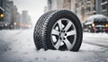 Closeup of one brand new car tire on a snowy winter road displayed Royalty Free Stock Photo