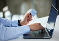 Closeup of one businessman spending money online with a credit card and laptop in an office. Making purchase transaction Royalty Free Stock Photo