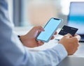 Closeup of one businessman spending money online with a credit card and phone in an office. Making purchase transaction Royalty Free Stock Photo