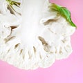 Closeup one half head fresh organic cauliflower on a bright pink background. Minimalistic, natural, lifestyle.Concept food blog, Royalty Free Stock Photo