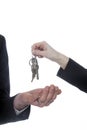 Closeup of one hand with key ring hands over keys to other hand Royalty Free Stock Photo