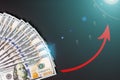 Closeup of one hundred dollars banknote on black background. Business finance and money concept, red arrow growing graph