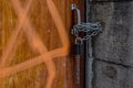 Closeup of one old wooden door locked by padlock and chain. Royalty Free Stock Photo